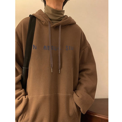 Brown hoodie with text on the chest against a neutral background